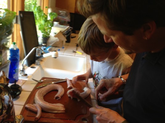 Dan trying to carve up the catch with Ben watching