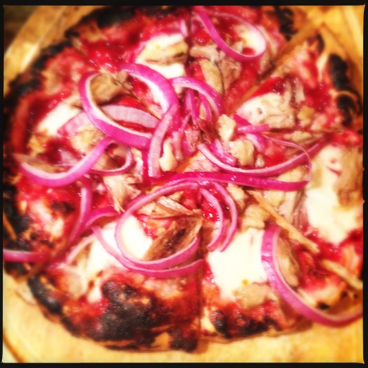 Pizza with homemade Chinese plum sauce, duck confit and red onion