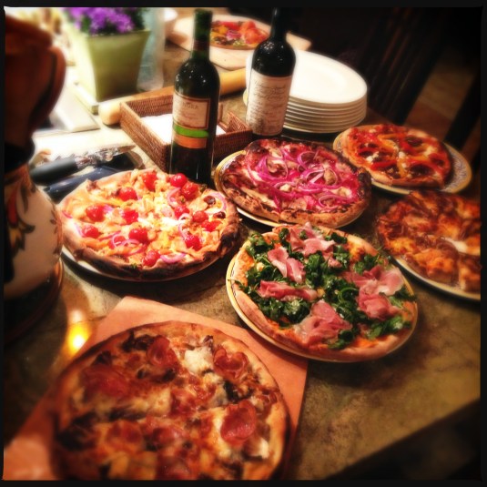 Pizzas (clockwise from top left): smoked salmon and cream cheese; duck with Chinese plum sauce and red onions; roasted peppers and feta; spicy calamari; arugula and proscuitto di Parma; and wild mushroom with radicchio and pancetta.