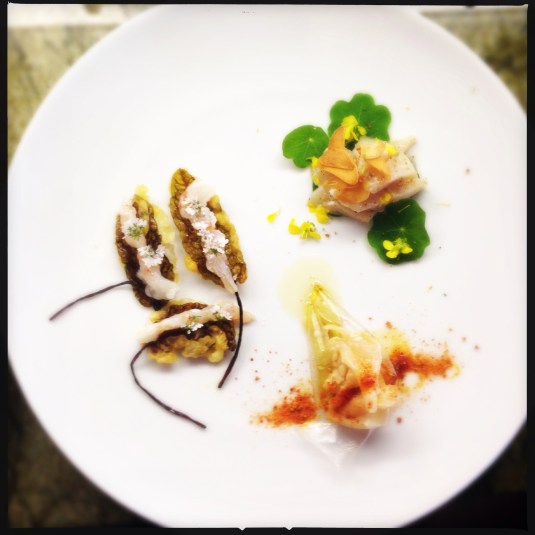 Trio of ceviches (l to r): sorrel lace tempura with sweet shrimp and cilantro blossoms; red snapper with ponzu, kudzu chip and tomato powders; and hamachi with mustard flowers, yuzu and white truffle oil on nasturtium leaves