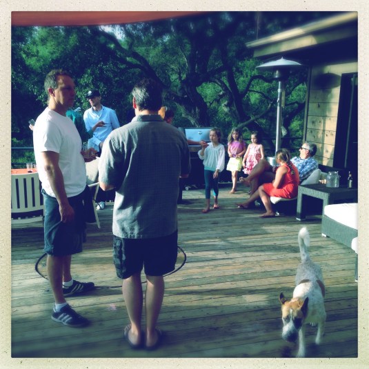 Guests and their mint juleps, dogs and kids out on the deck