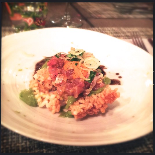 Ahi ceviche on puffed rice cakes with caramelized onion salsa