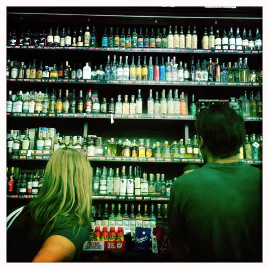 Erin and Alex face off the mezcal wall at the Ramirez warehouse.